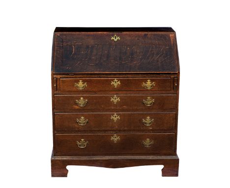 A George III oak bureau, the fall front enclosing a fitted interior with central arched recess with secret drawer to arch, si