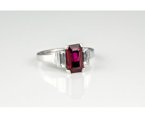 A fine 18ct white gold, ruby and diamond three stone ring, the approx. 2ct emerald cut ruby of fine colour and clarity, over 