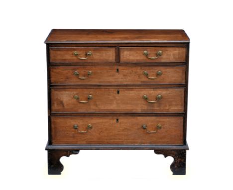 A George III mahogany chest of drawers, late 18th century, the cross banded top over two short and three long graduated cross
