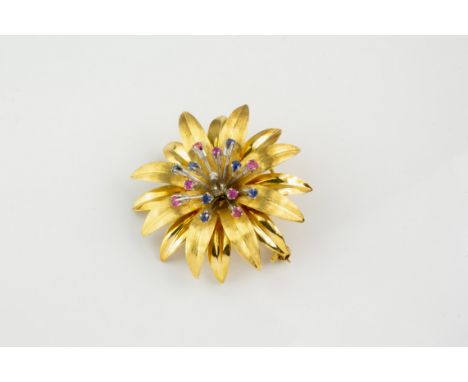 An 18ct gold, ruby, sapphire and diamond flower brooch, the two-colour gold chrysanthemum style flower set to the stamens wit