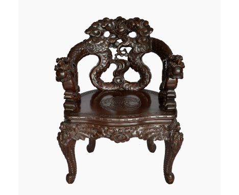 A Chinese carved dragon armchair, c.1900, the carved, brown lacquered softwood chair with a pierced back formed by two intert