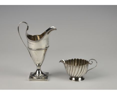 A George III silver cream jug, Charles Chesterman II, London 1787, of slender helmet form with beaded rim and girdle, moulded