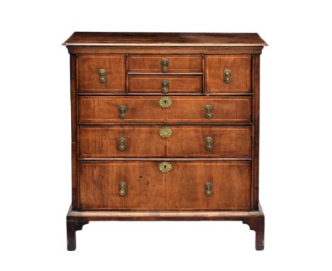 A Queen Anne walnut veneered chest of drawers, formerly the top of a chest on chest, c.1710, the oak top with everted corners
