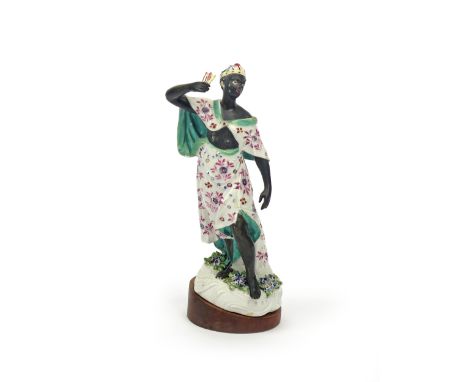 A large Derby figure of an Abyssinian Archeress  c.1765, wearing a patterned robe and holding arrow flights aloft in her righ