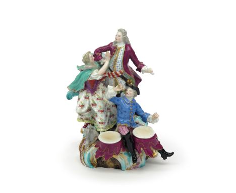 A Meissen figure group  19th century, modelled with a gallant standing on top of scrolled rockwork with a maiden appealing to