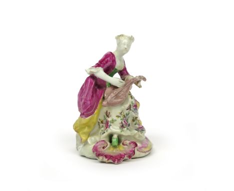 An early Derby figure of a female musician  c.1756-58, possibly emblematic of Hearing, seated and playing the mandolin, weari