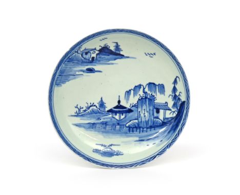 A Vauxhall blue and white saucer  c.1755-60, painted in a deep blue with pagodas beneath willow in a Chinese island landscape