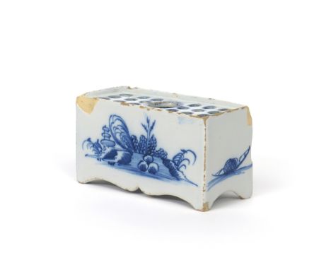 A small delftware flower brick  c.1750, the rectangular form painted in blue with a stylized pagoda landscape, the top set wi