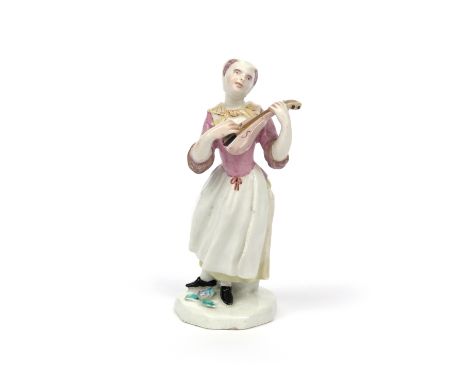 A Bow figure of a female lutenist  c.1753-55, after a Meissen figure by J F Eberlein, standing and holding her instrument clo