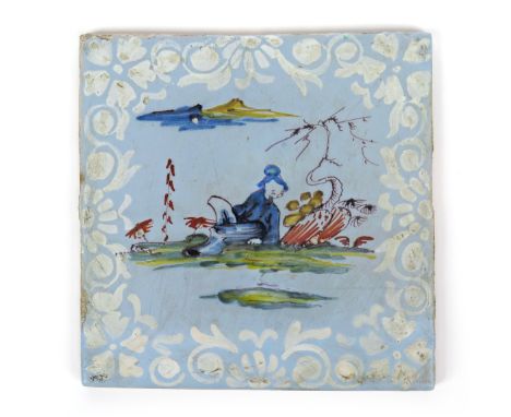 A Bristol delftware tile  c.1765, painted in polychrome enamels with a Chinese figure seated beneath a bare tree, within a bi