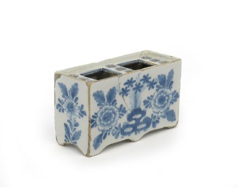 A delftware flower brick  c.1750, the rectangular form painted in blue with sprays of Oriental flowers beside holey rockwork,