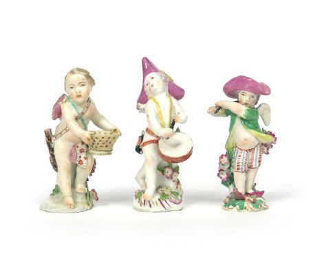 Three Chelsea figures of Cupid in Disguise  c.1760, one as a musician, playing a drum and wearing a pink tricorn hat, another