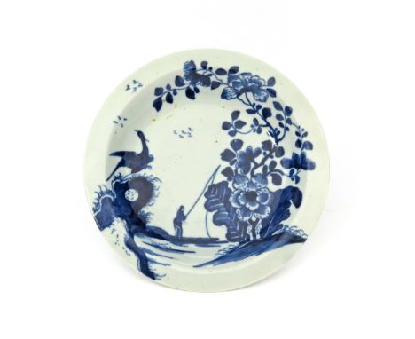 A Worcester blue and white fingerbowl stand c.1758, painted with the Cormorant pattern, the eponymous bird perched atop a hol