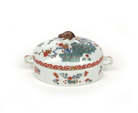 A Meissen sugar box and cover c.1730-35, the oval form decorated in the Kakiemon palette with birds on and beside prunus bran
