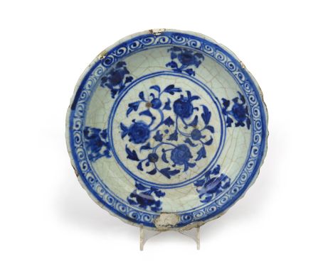 A Safavid 'Kubachi' dish  16th century, decorated in rich underglaze blue with a stylized chrysanthemum spray, the cavetto wi