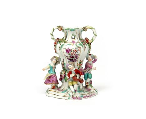 A Chelsea figural pot pourri vase  c.1759, the lobed baluster vase flanked by three figures dancing and playing a hurdy-gurdy