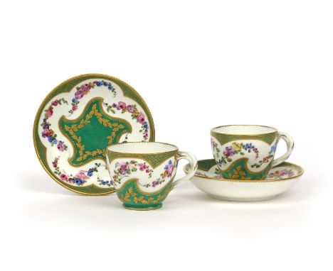 A pair of Sèvres cups and saucers  2nd half 18th century, painted with garlands of flowers within a shaped cinquefoil panel o