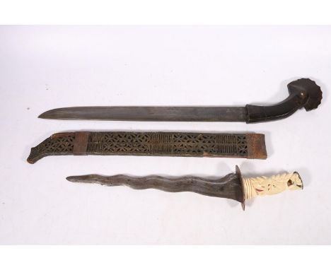 Indonesian kris type dagger with flamberge type blade and carved bone handle, 42cm long and a Indonesian short sword with bir