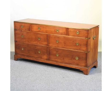 A modern military style yew wood chest, containing an arrangement of seven drawers153w x 46d x 78h cmOverall it is complete a