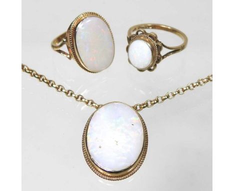 A 9 carat gold opal ring, 3g, size K, approximately 13 x 20mm, together with a 9 carat gold opal ring, with an openwork surro