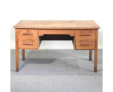 A mid 20th century light oak kneehole desk, on square legs137w x 75d x 75h cm