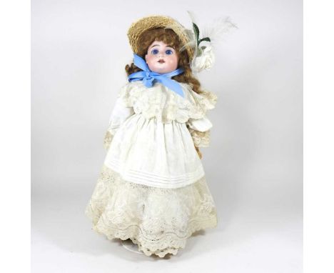 An Armand Marseilles bisque headed doll, no.1894, AM5 dep, dressed in old clothes, on stand, 47cm highThe head appears to be 