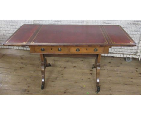 A 19th century walnut cross banded sofa table, with tooled leather inlaid top, with dummy and real drawers, raised on four sp