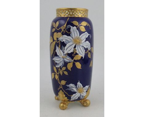 A Royal Worcester spill vase, with knurl feet and pierced neck, decorated with flowers and gilt foliage, height 8.5ins&nbsp;C