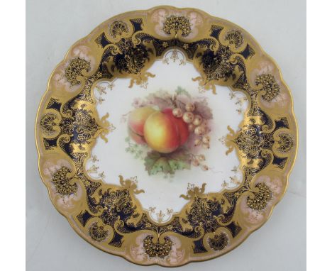 A Royal Worcester plate, decorated with a panel of fruit by Seabright, to a blue gilt and pink boarder, diameter 9ins&nbsp;Co