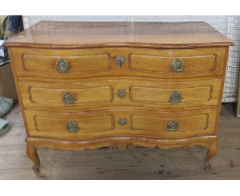 An Antique double fronted serpentine continental commode chest, of three drawers, raised on short cabriole legs, width 52ins,
