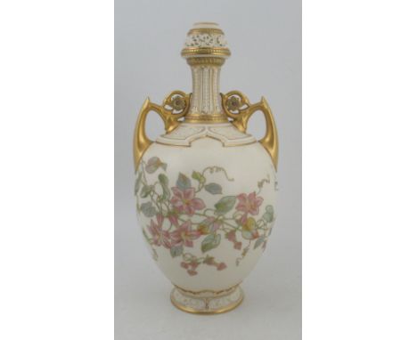 A Royal Worcester gilded ivory vase, decorated with foliage with gilt handles and pierced neck, shape No 1200, height 14insCo