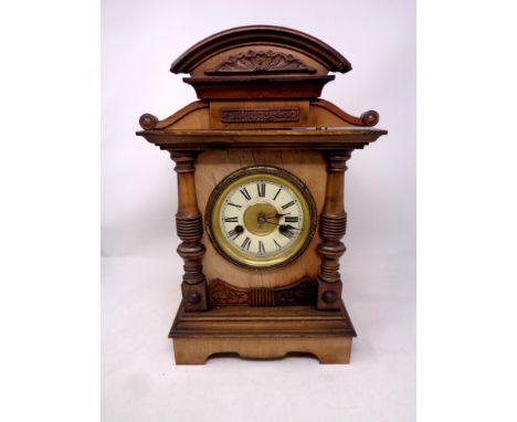 A 19th century beech cased mantle clock with enamel dial 