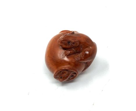 A Japanese carved fruitwood netsuke - Rats on a barrel. 