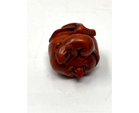 A Japanese carved fruitwood netsuke - Rats on a pumpkin. 