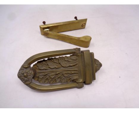 An antique brass door knocker together with one further door knocker  