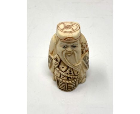 A Japanese carved bone netsuke - Village elder with a basket at his feet. 