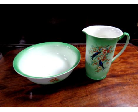 A Staffordshire transfer printed jug and basin with panels of birds on branch  