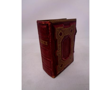 A small tooled and gilt leather metal bound portrait album  