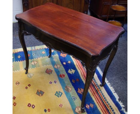 A mahogany card table, serpentine rectangular top, cabriole legs, acanthus carved knees, knurled feet, ceramic castors