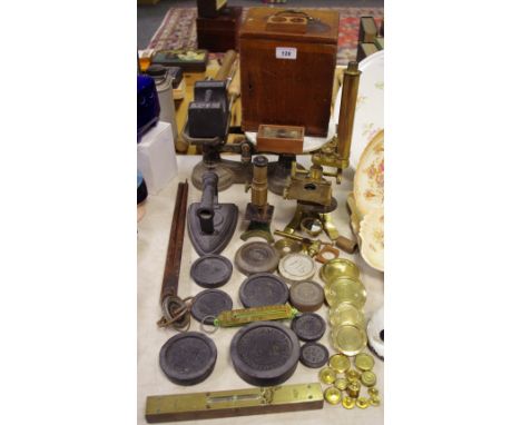 An early 20th century brass microscope; a student's microscope; a Marples &amp; Sons spirit level; a counterbalance weighing 