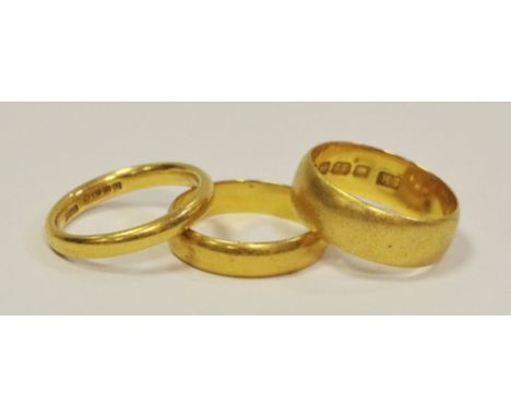 A 22ct gold half barrel wedding band, size L 1/2 5.4g; a 22ct gold half barrel wedding band size L 3.4g: another size K 3.8g 