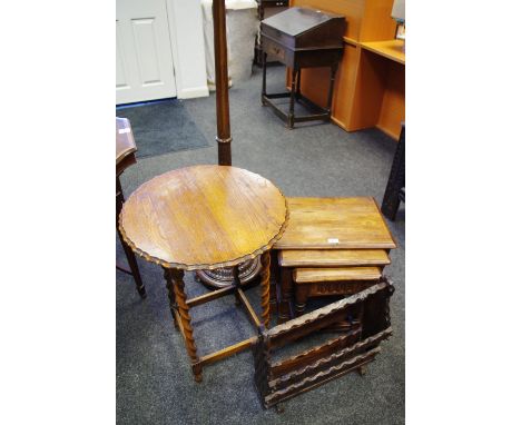 An oak barley twist occasional table, scalloped circular top; an oak nest of three tables; an oak magazine rack; an oak stand