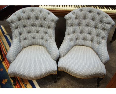 A pair of Napoleon III style nursing chairs, button back, serpentine stuffed overseat, French cabriole forelegs