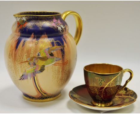 A Carlton Ware Sketching Bird jug globular form, enamelled in polychrome on a matt peach and cobalt ground highlighted in gil