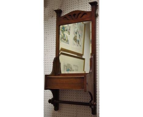 A mahogany wall mirror with trinket box and hand towel rail to base