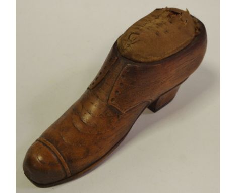 An Edwardian treen pin cushion in the form of a 19th century shoe