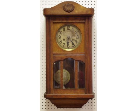 An early 20th century oak wall clock, c.1930