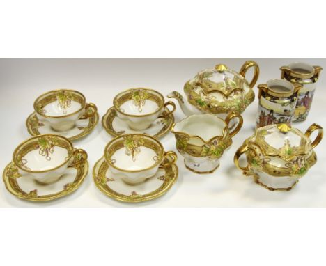 A Noritake lobed tea service with raised gilt foliage &amp; band picked out in colours comprising teapot, four cups &amp; sau