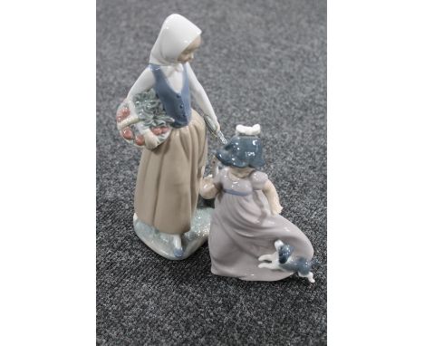 Two Nao figures : child with puppy and lady with goose 