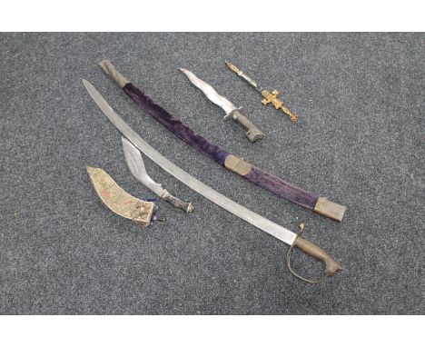 An Indian sword with scabbard and three other Eastern knives 